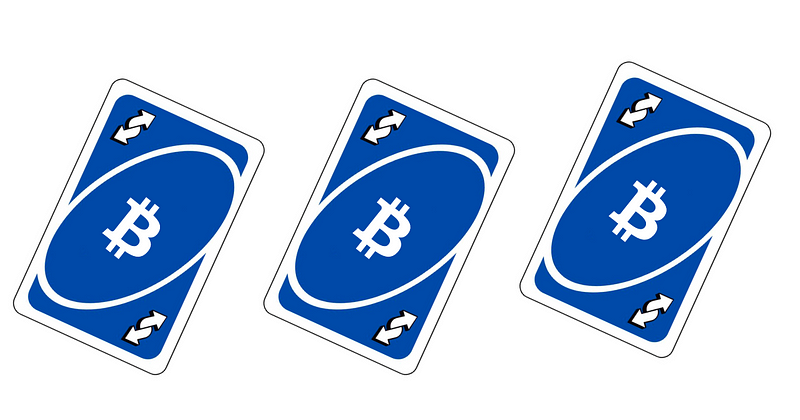 3 blue colored Uno reverse cards with the Bitcoin logo in the middle of each card